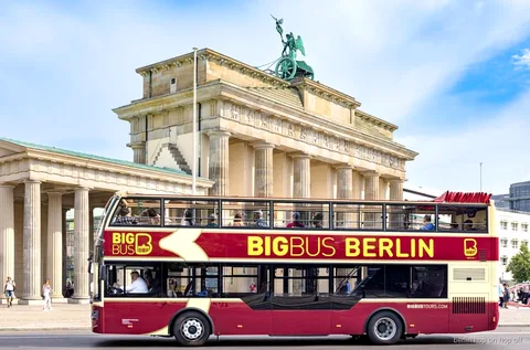 Big Bus Berlin hop-on hop-off tour open-top double-decker bus passing the Brandenburg Gate