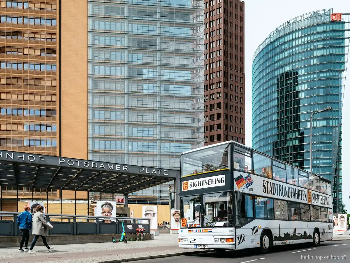 Bus a due piani hop on hop off di Berlino alla stazione di Potsdamer Platz accanto a torri di vetro