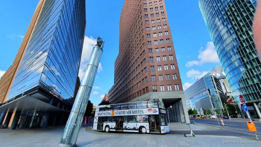 Berlin hop-on hop-off tour bus with live commentary guide passing Potsdamer Platz